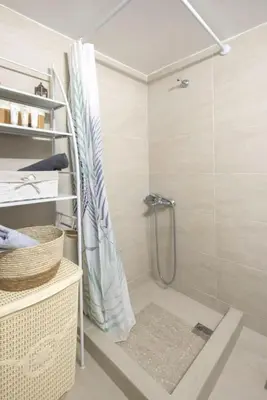 a shower with a shower curtain in a bathroom at Spacious Sunny Apartment in Athens