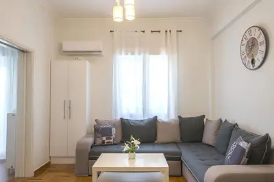 a living room with a couch and a table at Spacious Sunny Apartment in Athens