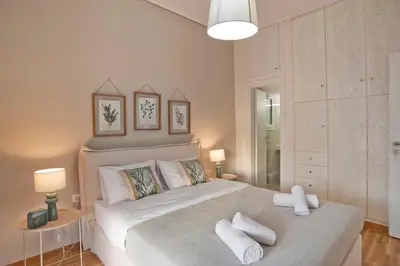 a bedroom with a large bed with white pillows at Kary's Acropolis View Luxury 2BR, 2 BA, Jacuzzi in Athens