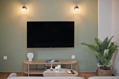 a living room with a flat screen tv on a wall at Kary's Acropolis View Luxury 2BR, 2 BA, Jacuzzi in Athens
