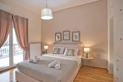 a bedroom with a large bed and a large window at Kary's Acropolis View Luxury 2BR, 2 BA, Jacuzzi in Athens