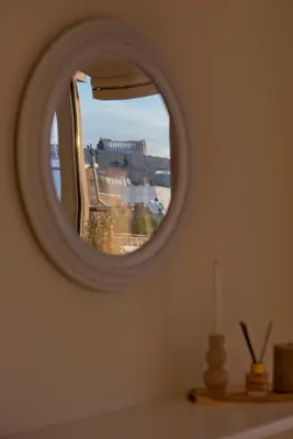 a mirror in a room with a view of a building at Kary's Acropolis View Luxury 2BR, 2 BA, Jacuzzi in Athens