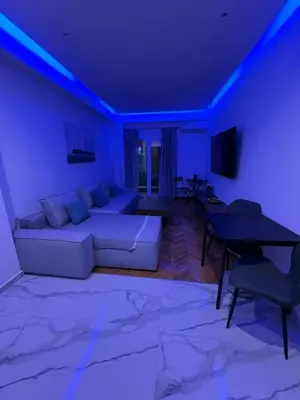 a living room with a couch and a table at Zea Sea View Apartment in Piraeus