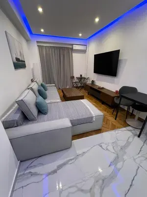 a bedroom with a bed and a flat screen tv at Zea Sea View Apartment in Piraeus