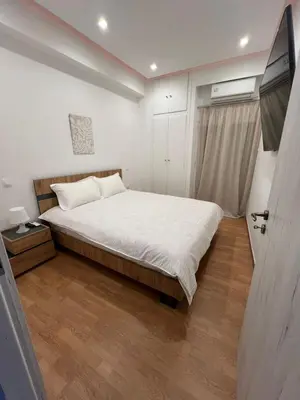 a bedroom with a bed and a window and a door at Zea Sea View Apartment in Piraeus