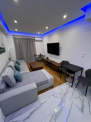 a bedroom with two beds and a flat screen tv at Zea Sea View Apartment in Piraeus