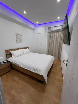 a bedroom with a bed and a tv in it at Zea Sea View Apartment in Piraeus