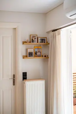 a bathroom with a shower curtain and a radiator at Atherial Studio in Athens