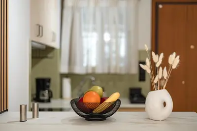 a bowl of fruit and vegetables on a counter in a kitchen at Atherial Studio in Athens