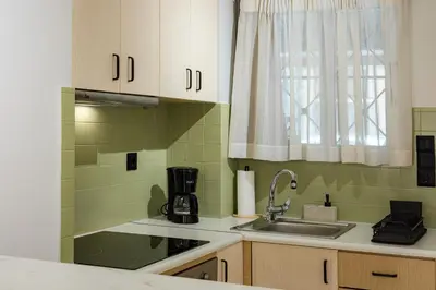 a small kitchen with a sink and a window at Atherial Studio in Athens