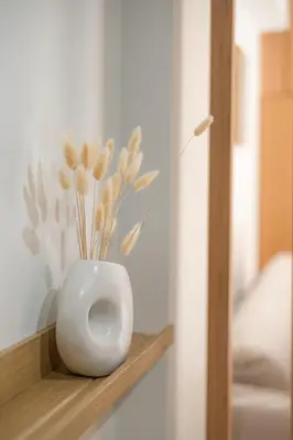 a white vase sitting on a shelf in a room at Atherial Studio in Athens