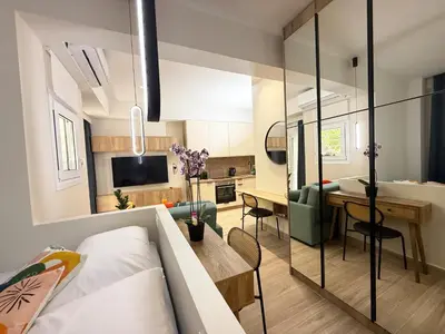 a small apartment with a bedroom and a living room at Petit and Peaceful Retreat in Athens