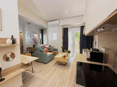 a living room with a couch and a table at Petit and Peaceful Retreat in Athens
