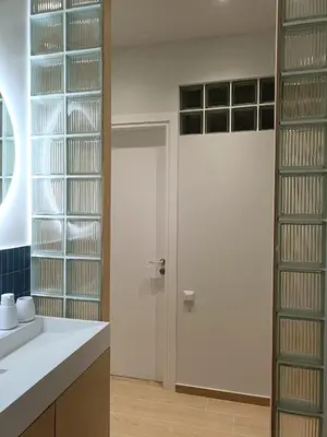 a kitchen with a sink and a door with glass shelves at Luxury Residency II Filolaou Blue in Athens