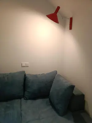 a living room with a couch and a red hanger at Luxury Residency II Filolaou Blue in Athens