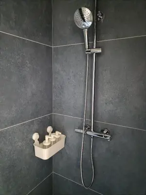 a shower with a shower head in a bathroom at Luxury Residency II Filolaou Blue in Athens