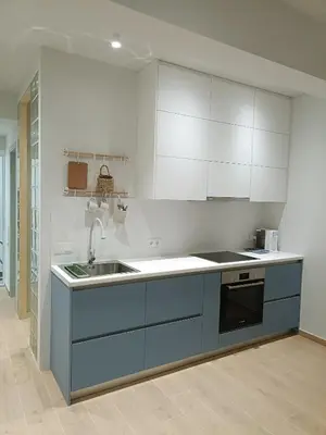 a kitchen with blue and white cabinets and a sink at Luxury Residency II Filolaou Blue in Athens
