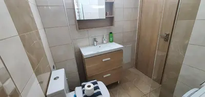 a small bathroom with a sink and a shower at A few minutes from Siggrou Street in Athens