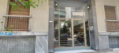 a store front with glass doors on a building at A few minutes from Siggrou Street in Athens