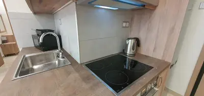 a kitchen with a sink and a counter top at A few minutes from Siggrou Street in Athens