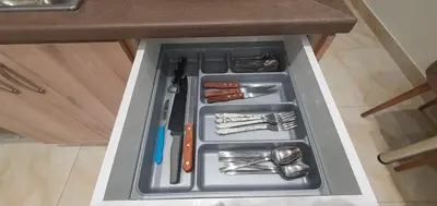 a drawer in a counter with utensils in it at A few minutes from Siggrou Street in Athens