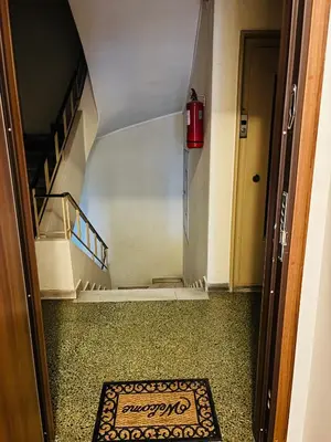 a hallway with a stairway with a rug on the floor at Elysian Αpartment II in Athens