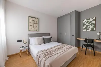 a bedroom with a bed with a desk and a chair at The Exarchia Hideout by UPSTREET in Athens