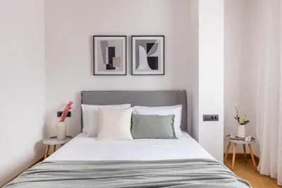 a bedroom with a large bed with two tables at The Exarchia Hideout by UPSTREET in Athens