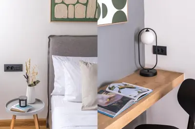 a bedroom with a bed and a desk with a lamp at The Exarchia Hideout by UPSTREET in Athens
