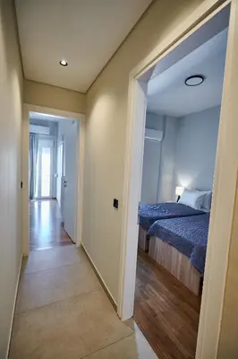 a hallway leading to a bedroom with a bed at Brand new Athens Museum Apt in Athens