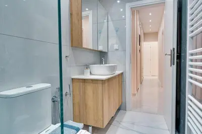 a bathroom with a sink and a toilet and a shower at Seaside bliss in Alimos ideal for families ! in Athens