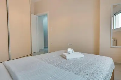 a bedroom with a bed with a towel on it at Seaside bliss in Alimos ideal for families ! in Athens