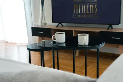 two coffee tables in front of a tv at Seaside bliss in Alimos ideal for families ! in Athens