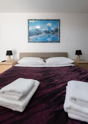 a bedroom with a bed with white towels on it at Villa PAPADATES ARTEMIS in Barbaliáki