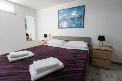 a bedroom with a large bed with two towels on it at Villa PAPADATES ARTEMIS in Barbaliáki