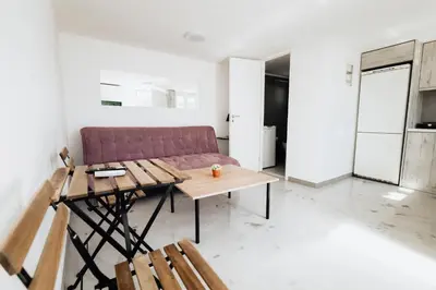 a living room with a purple couch and a table at Villa PAPADATES ARTEMIS in Barbaliáki