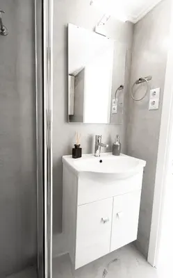 a bathroom with a white sink and a mirror at Villa PAPADATES ARTEMIS in Barbaliáki