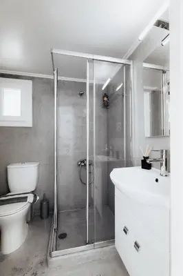 a bathroom with a shower and a toilet and a sink at Villa PAPADATES ARTEMIS in Barbaliáki