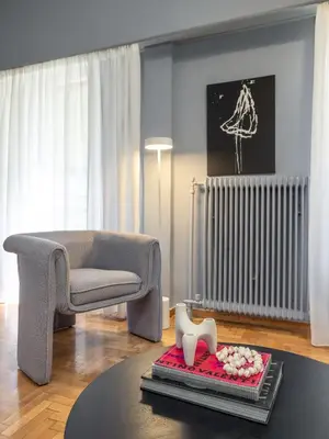 a living room with a couch and a chair at Contempo Athens in Athens