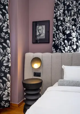 a bedroom with a bed and a table next to a bed at Contempo Athens in Athens