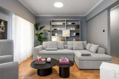 a living room with a couch and a table at Contempo Athens in Athens