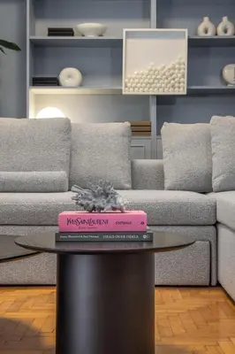 a pink book sitting on a table in front of a couch at Contempo Athens in Athens
