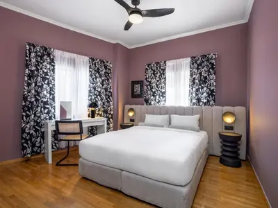 a bedroom with a large white bed and a desk at Contempo Athens in Athens