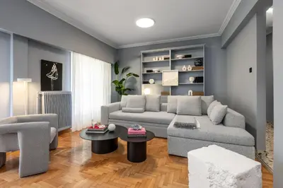 a living room with a gray couch and chairs at Contempo Athens in Athens