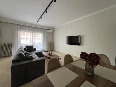 a living room with a couch and a table at J&N Living in Spáta