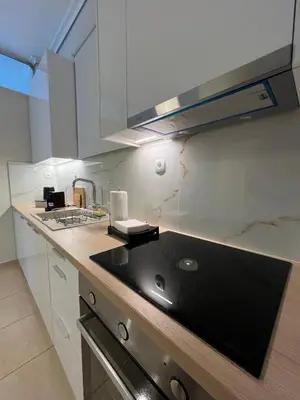 a kitchen with a sink and a counter top at J&N Living in Spáta