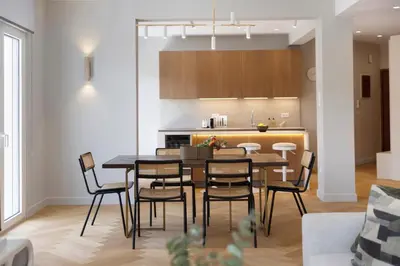 a dining room and kitchen with a table and chairs at Spacious Athenian escape, Koukaki in Athens