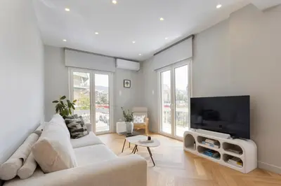 a living room with a couch and a flat screen tv at Spacious Athenian escape, Koukaki in Athens
