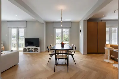 a living room with a table and chairs and a couch at Spacious Athenian escape, Koukaki in Athens