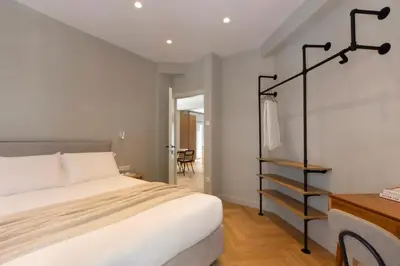 a bedroom with a large bed and a staircase at Spacious Athenian escape, Koukaki in Athens
